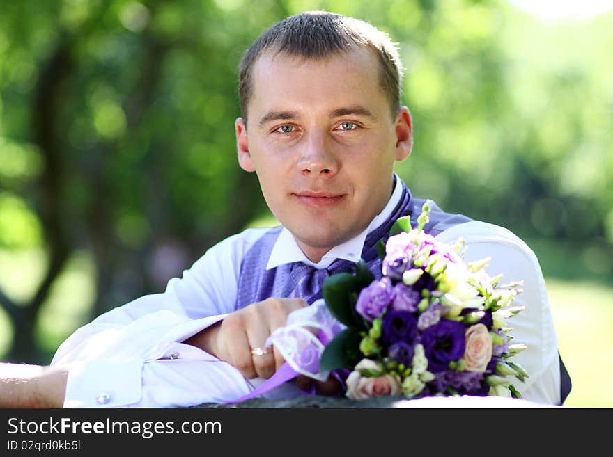 Portrait of the happy man in summer park