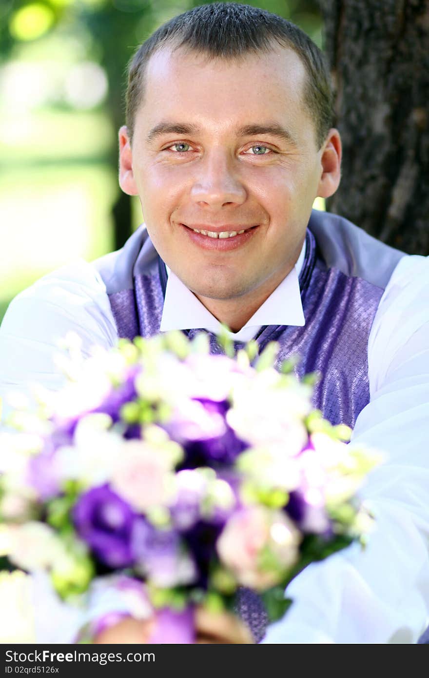 Portrait of the happy man in summer park