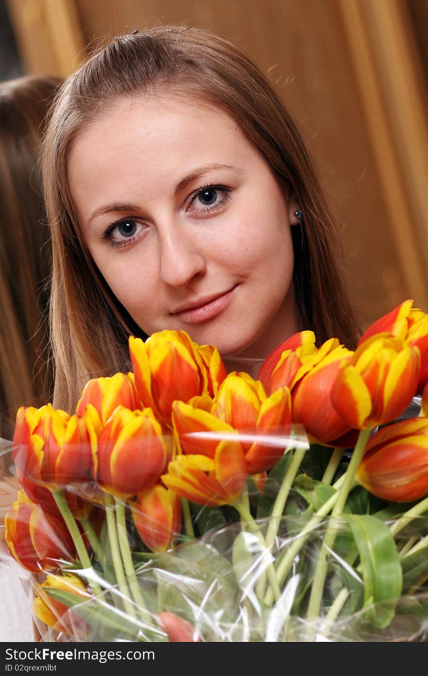Attractive blonde holding bunch of flowers