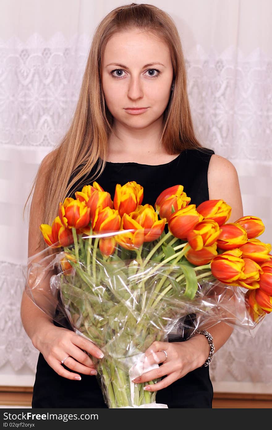 Attractive blonde holding bunch of flowers
