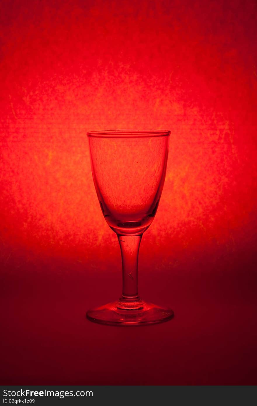 One glass on red background