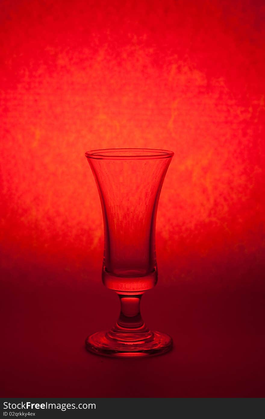 One glass on red color background