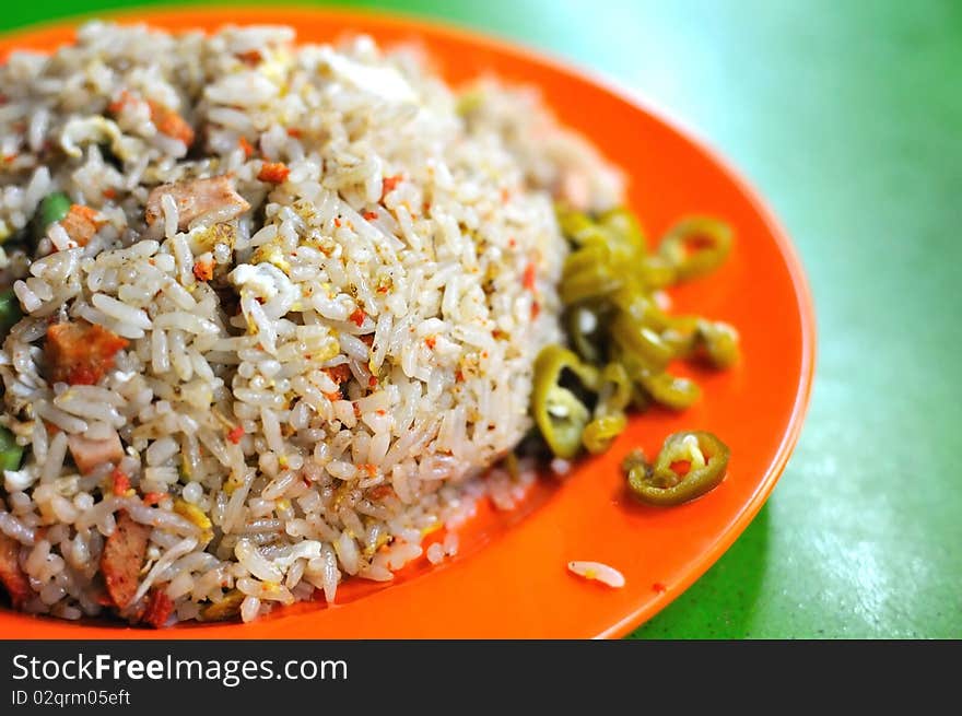 Chinese style fried rice with freshly cut green chili. Suitable for concepts such as diet and nutrition, healthy lifestyle, and food and beverage. Chinese style fried rice with freshly cut green chili. Suitable for concepts such as diet and nutrition, healthy lifestyle, and food and beverage.