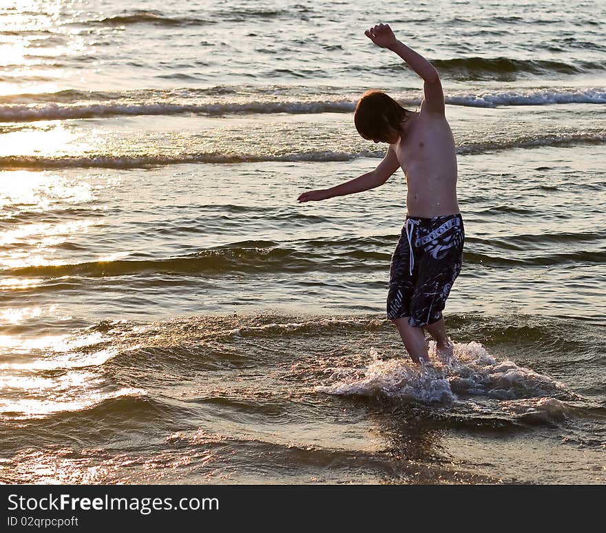 Teenage boy boarding in water. Teenage boy boarding in water