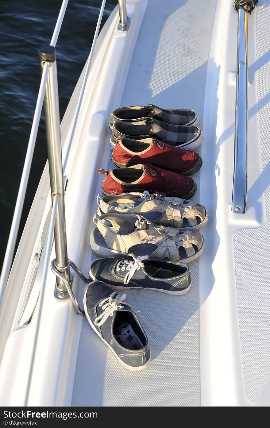 Pairs of shoes hanging out outside the sailboat deck. Pairs of shoes hanging out outside the sailboat deck.