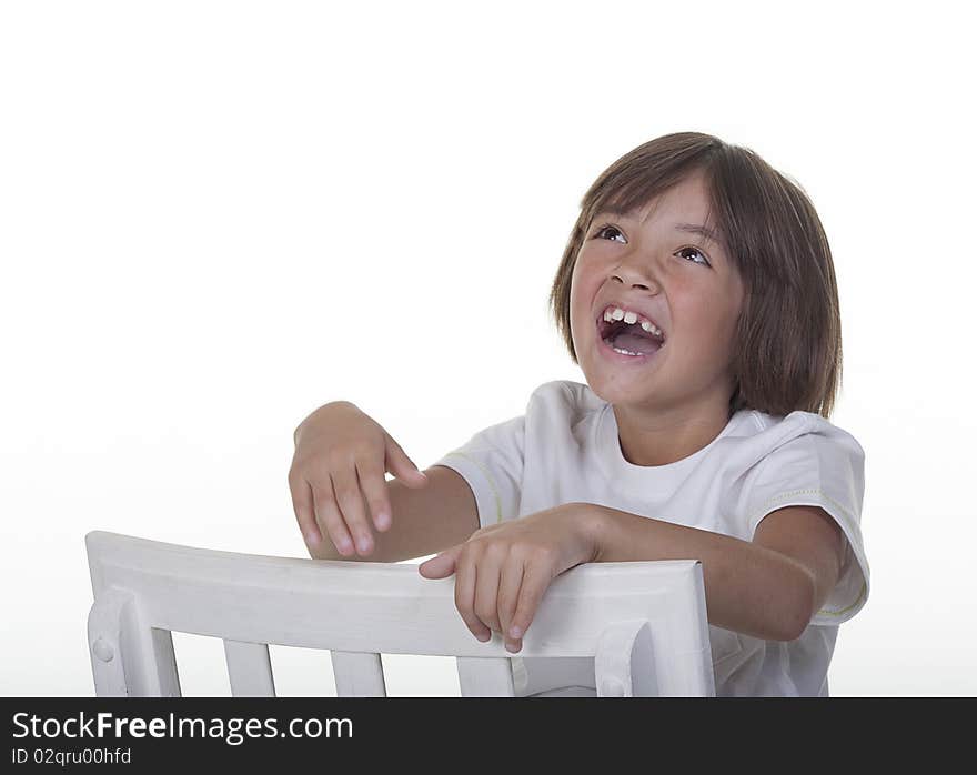 A young girl in a studio setting laughs loudly. A young girl in a studio setting laughs loudly.