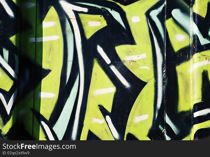 Colorful black and green and blue graffiti on the side of a train. Colorful black and green and blue graffiti on the side of a train