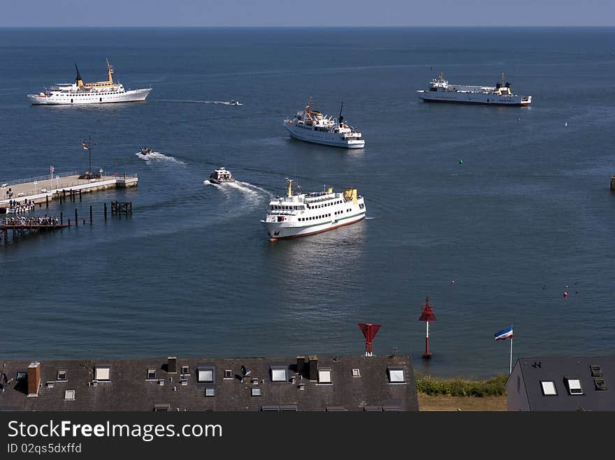 Ferry service close to Helgoland. Small boats carry passengers to bigger boats.