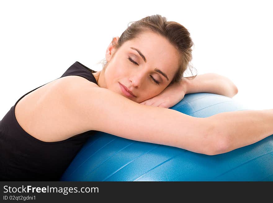 Young tired and very attractive woman with blue fitness ball, studio shoot isolated on white background. Young tired and very attractive woman with blue fitness ball, studio shoot isolated on white background