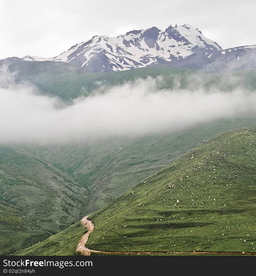 Way to Kazbegi mountain in Georgia, with dark clouds and green grass. Way to Kazbegi mountain in Georgia, with dark clouds and green grass