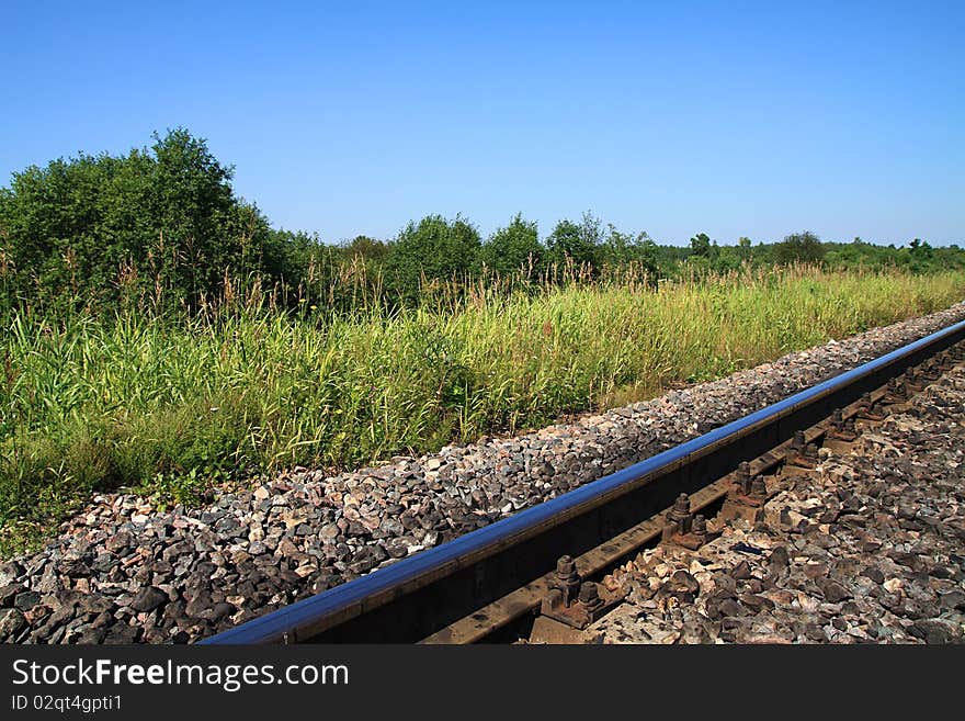 Railway rail on pebble embankment