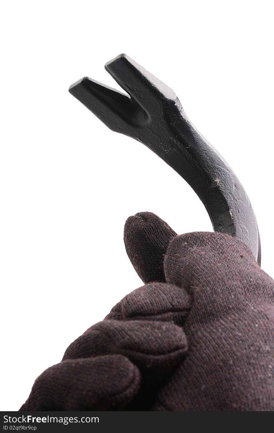 The hand in a black glove made of cloth holds crowbar.