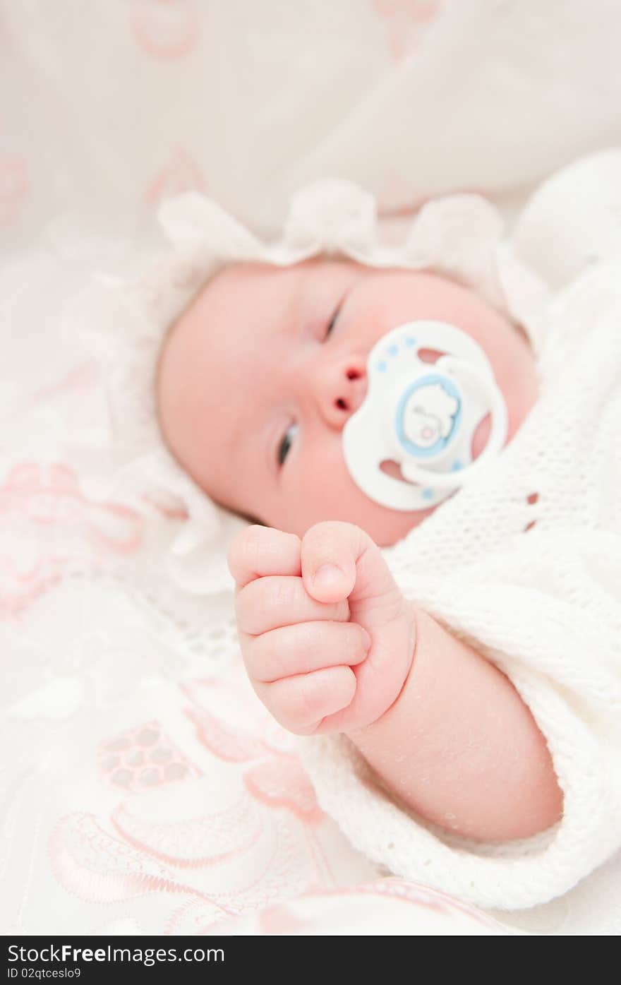 The image of the newborn child. Focus on a hand. The image of the newborn child. Focus on a hand