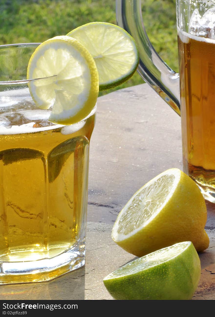 Refreshing summer drink with lemon and lime slices