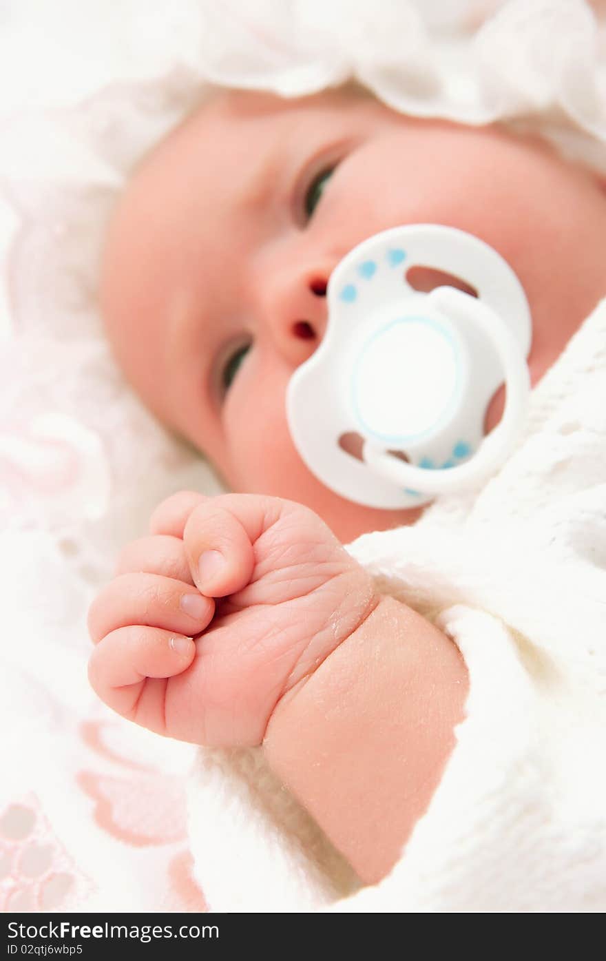 The image of the newborn child. Focus on a hand. The image of the newborn child. Focus on a hand