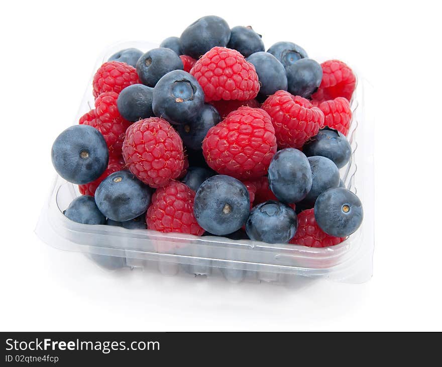 Transparent basket with a raspberry and a blueberry on a white background