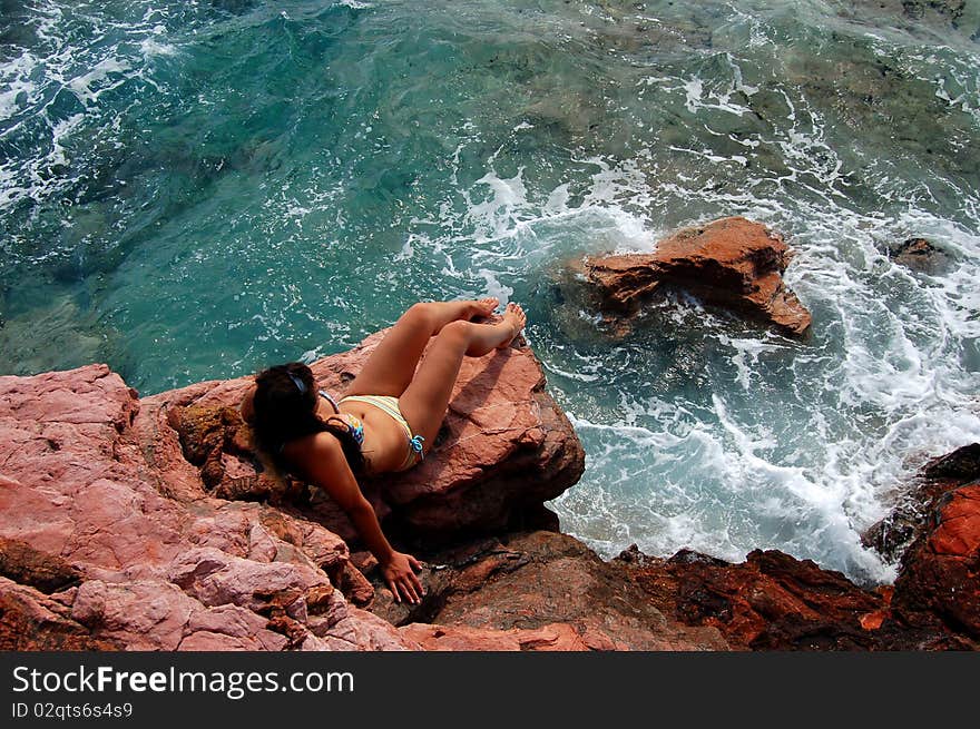 A girl on rocky beach