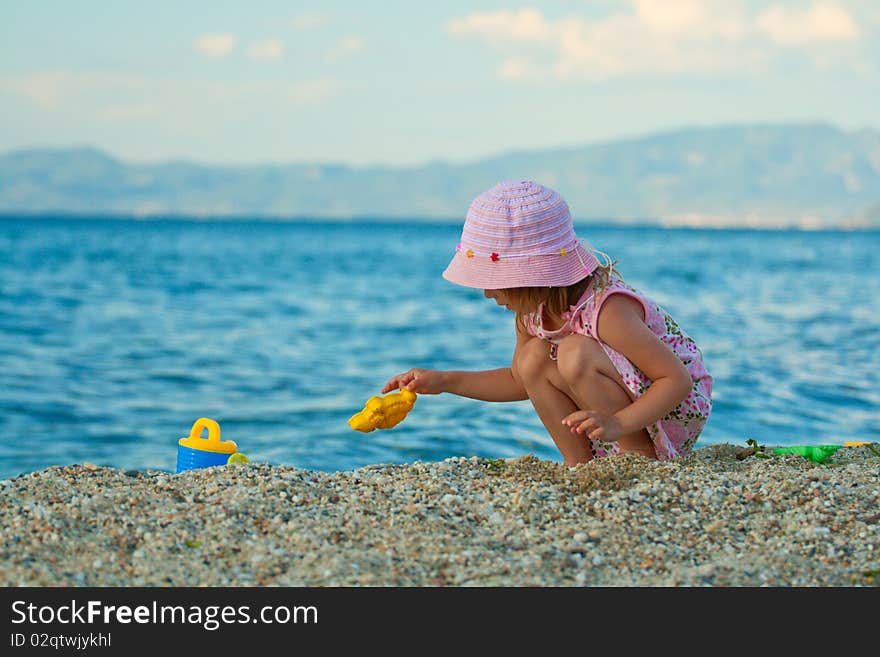 Little Pretty Girl Playing On The Beach.