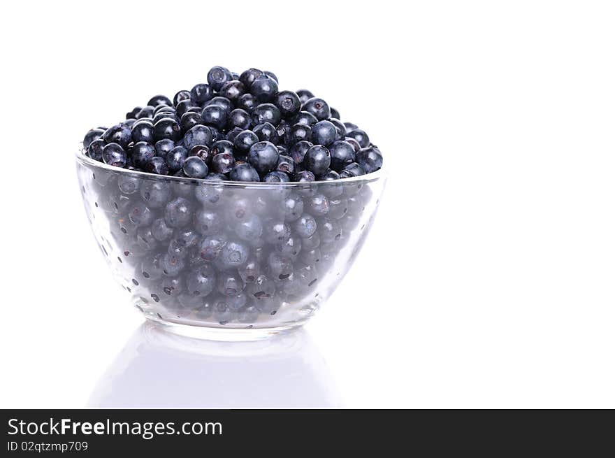 Blueberries in transparent glass dish with soft shadow on white background. Blueberries in transparent glass dish with soft shadow on white background