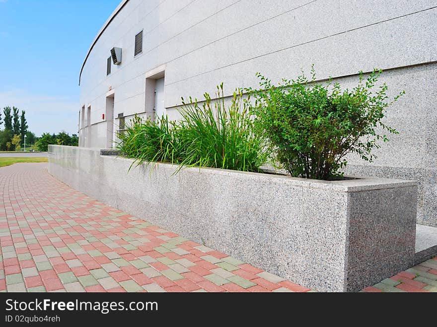 Granite plates and green bushes. Granite plates and green bushes