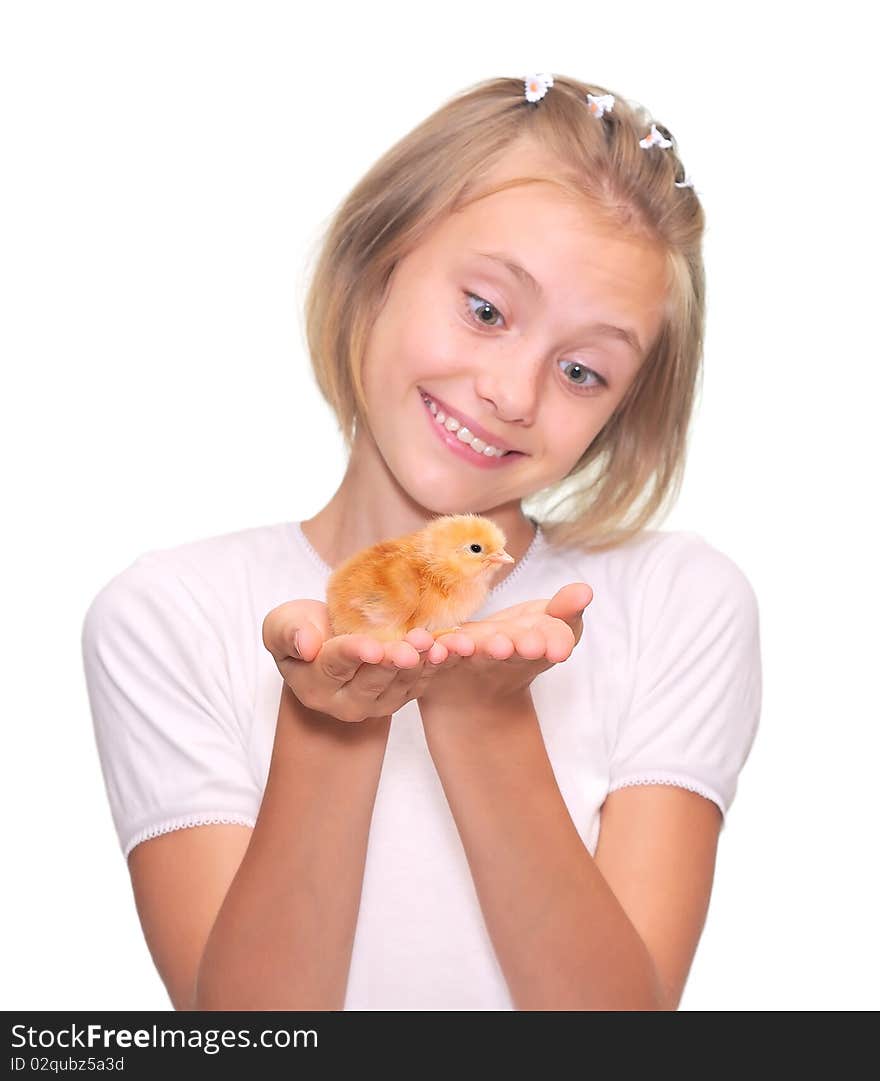 A happy little girl holding a baby chicken.