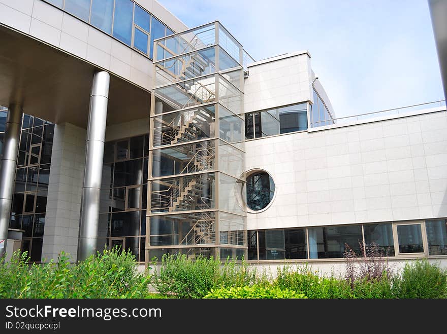 Building from glass and metal with a ladder