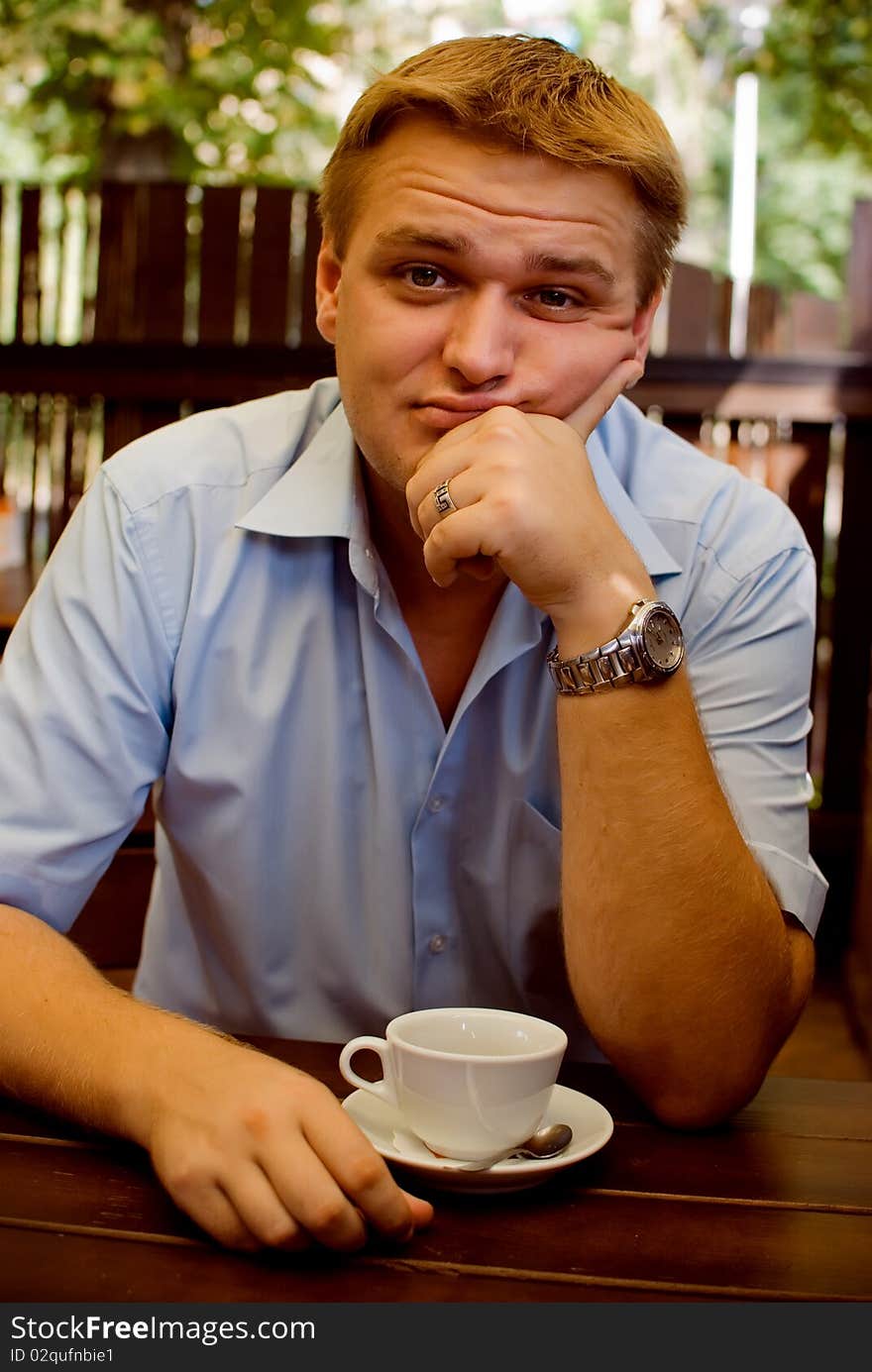 Young man drinking tea in a cafe. Young man drinking tea in a cafe