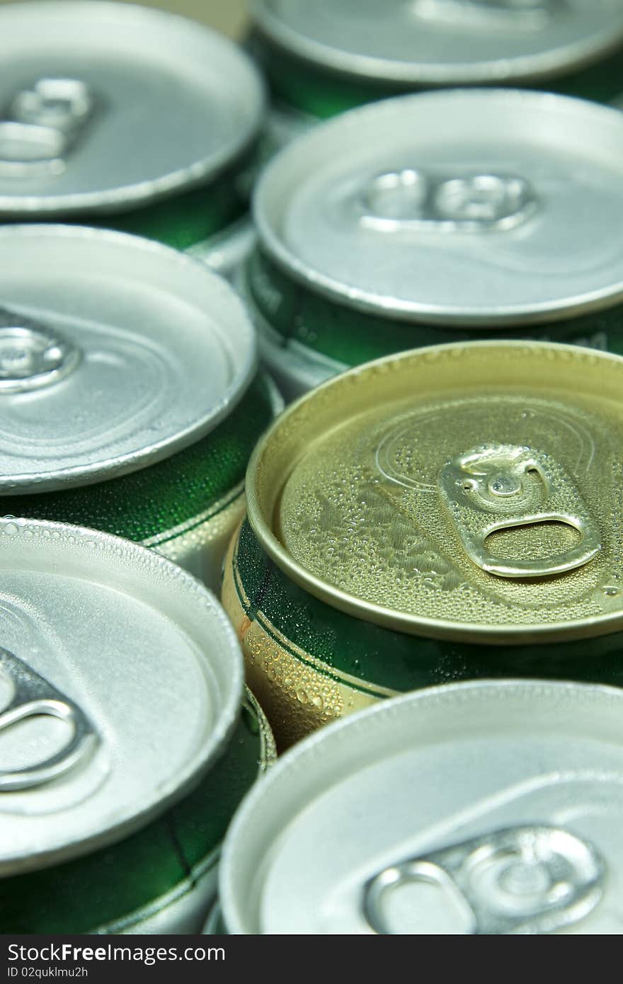 Many cans of beer with water drops