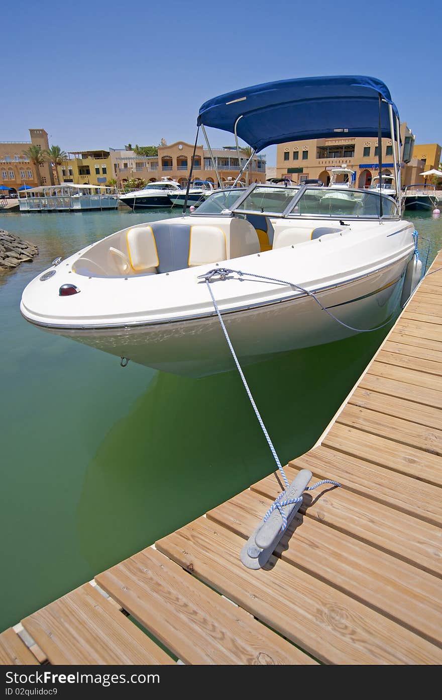 Luxury speedboat moored to a jetty