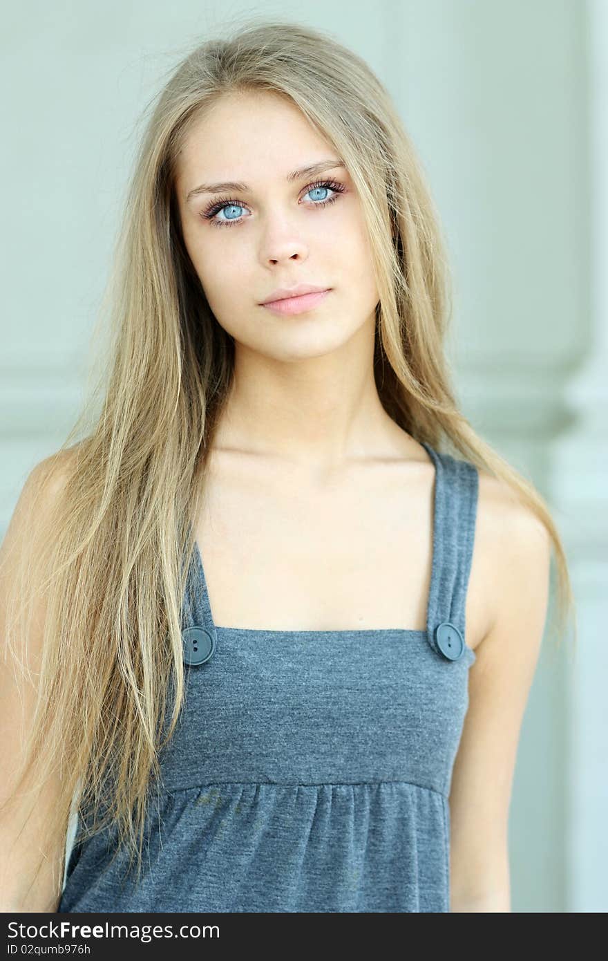 Beautiful woman standing against wall in background