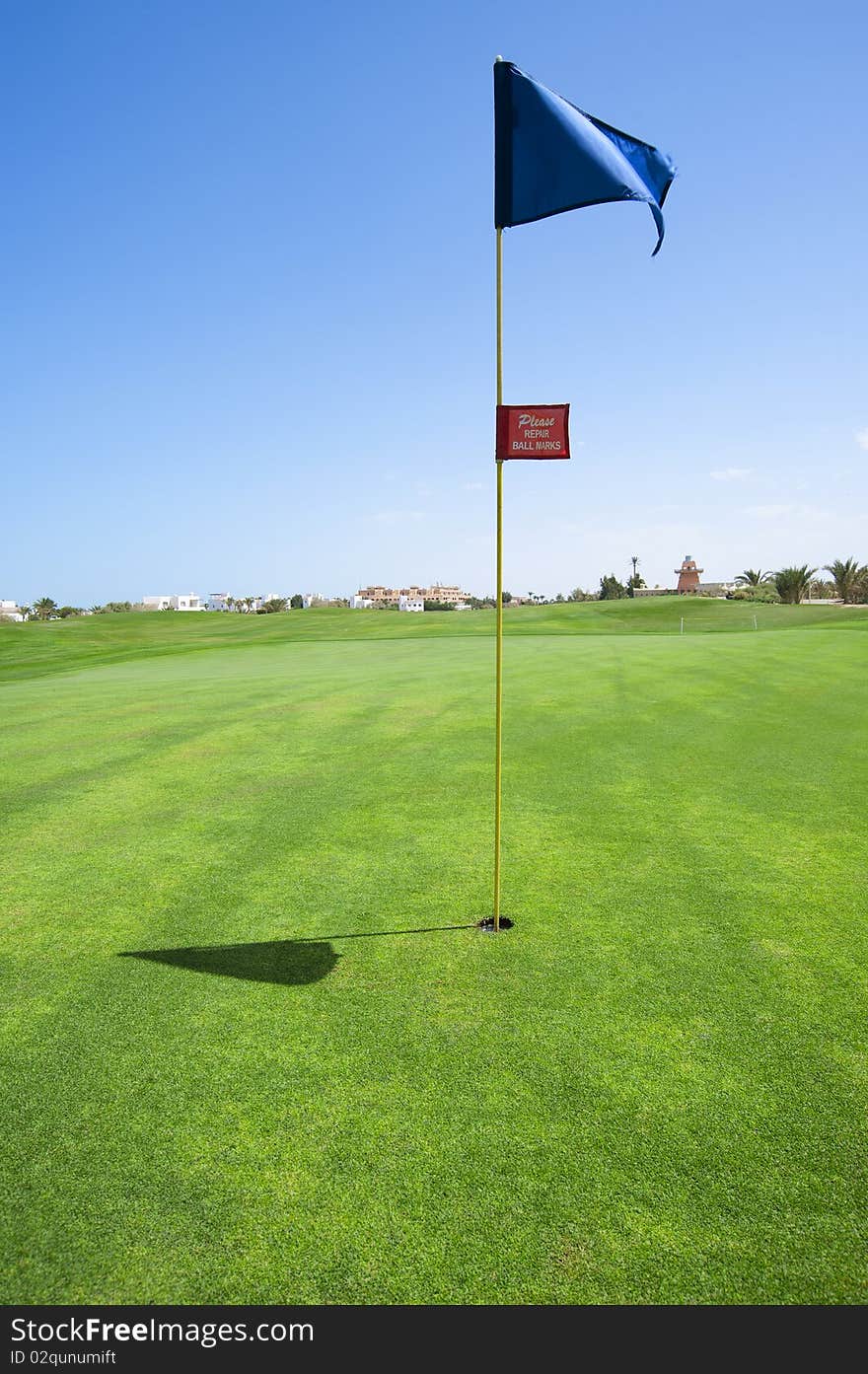 Golf flag in the hole on a couse green. Golf flag in the hole on a couse green