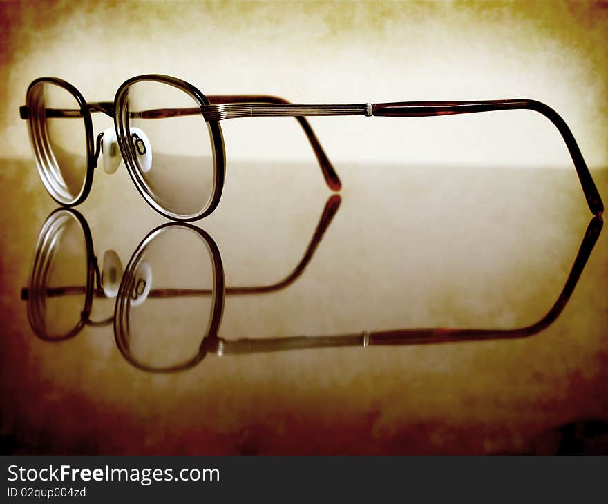 Closeup of Antique Eyeglasses on desk with reflection. Closeup of Antique Eyeglasses on desk with reflection