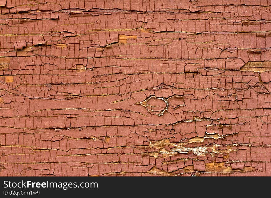 Old red oil paint peeling away from wood surface. Old red oil paint peeling away from wood surface.