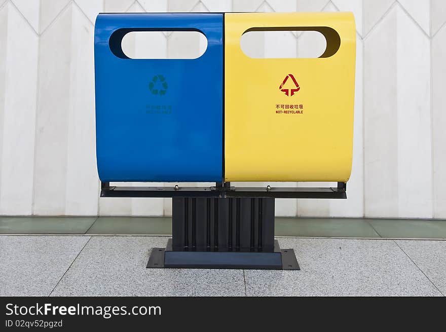 A waste and recycling bin placed side by side in a unique design. A waste and recycling bin placed side by side in a unique design.