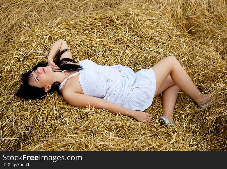 Woman is laying on a straw