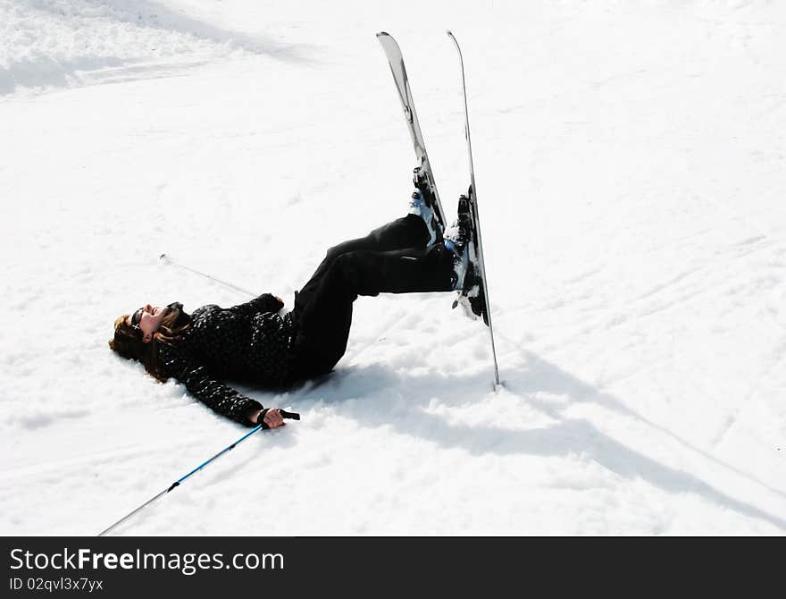 Skiing girl laying on the snow. Skiing girl laying on the snow