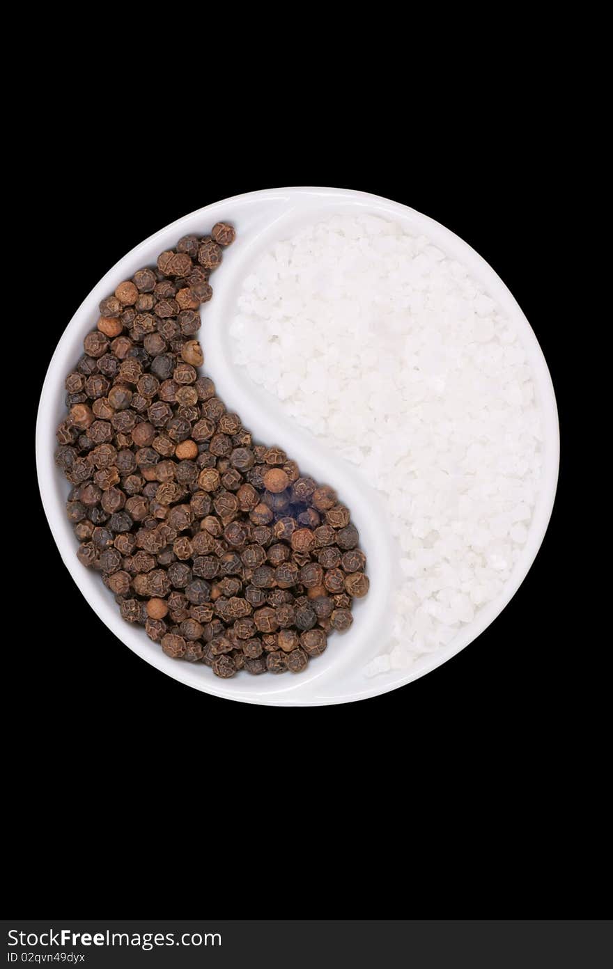 Black pepper and salt forming a Taijitu rappresentation. Studio shot over black background. Black pepper and salt forming a Taijitu rappresentation. Studio shot over black background.