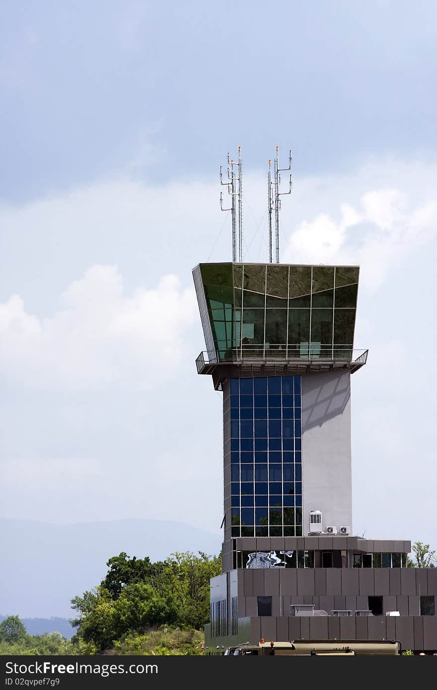 Airport control tower with sky in the background.