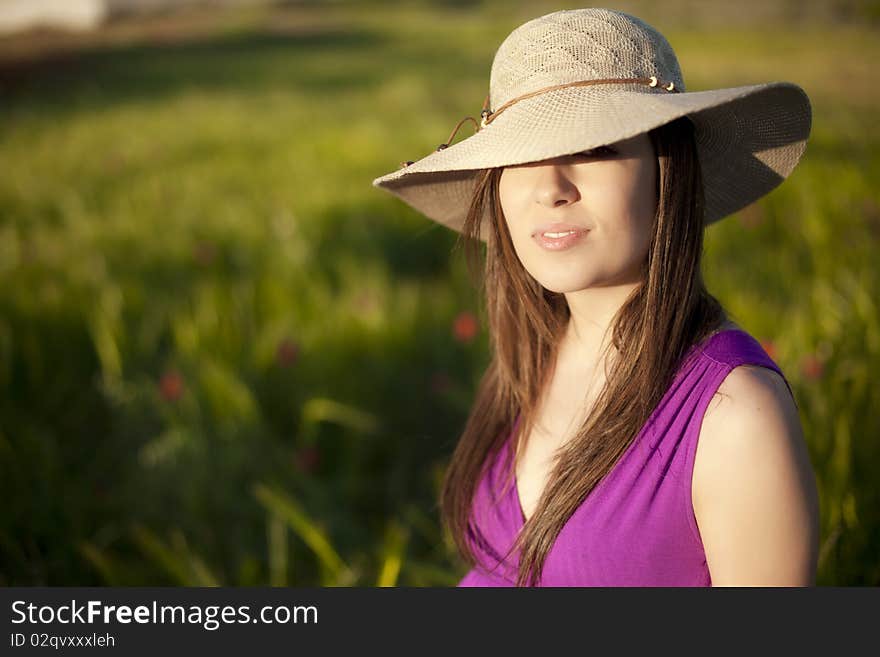 Young woman portrait wearing a big hat. Young woman portrait wearing a big hat.