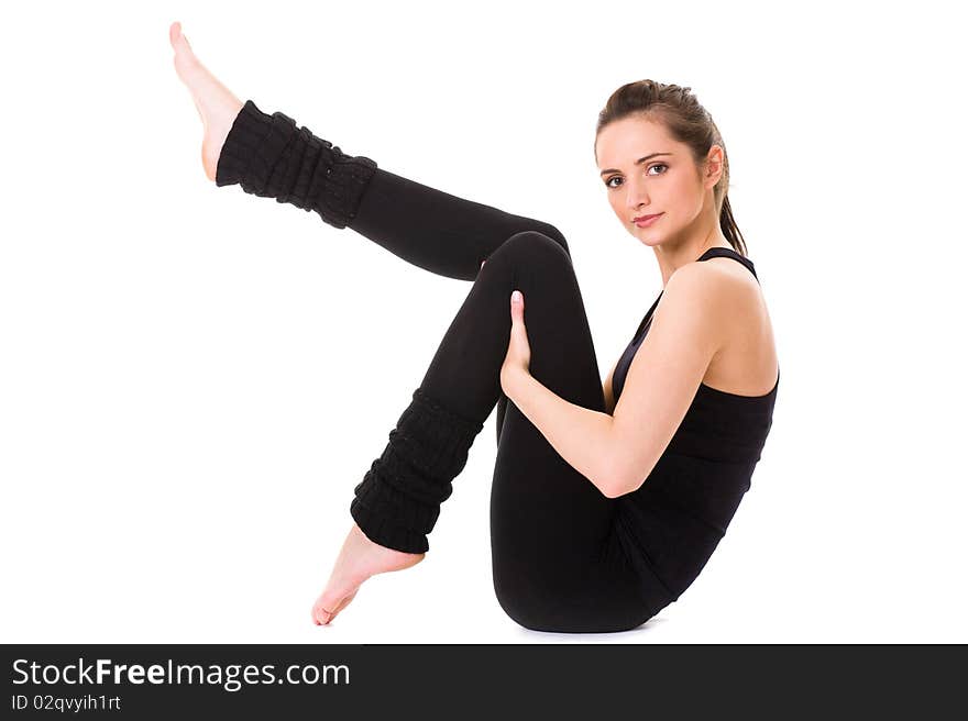 Young female doing some exercises on white floor