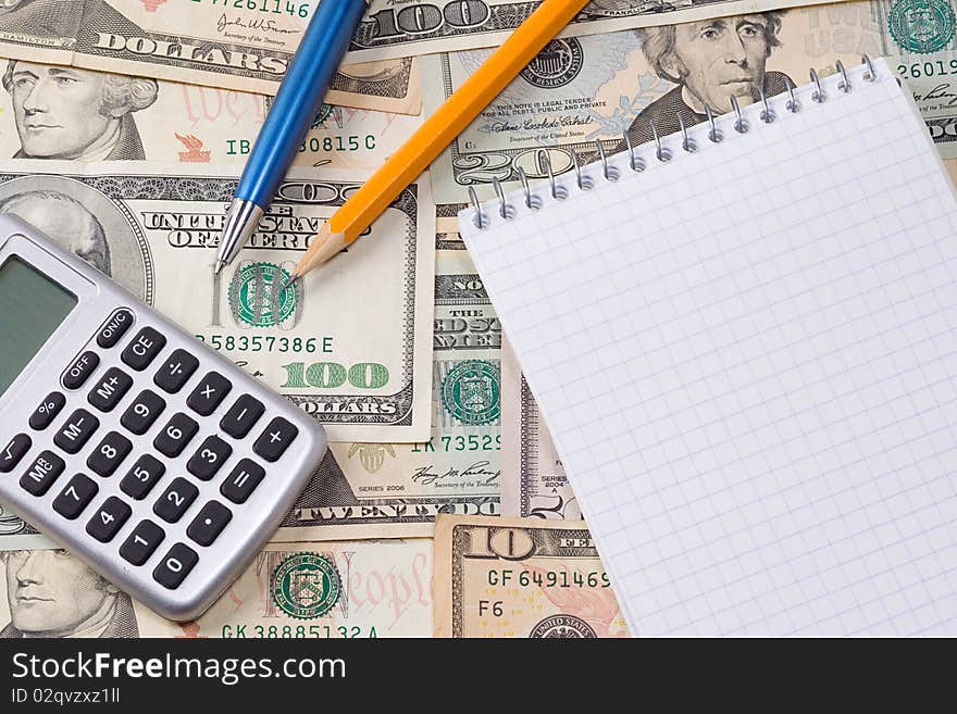 Calculator, pens and pad at dollars