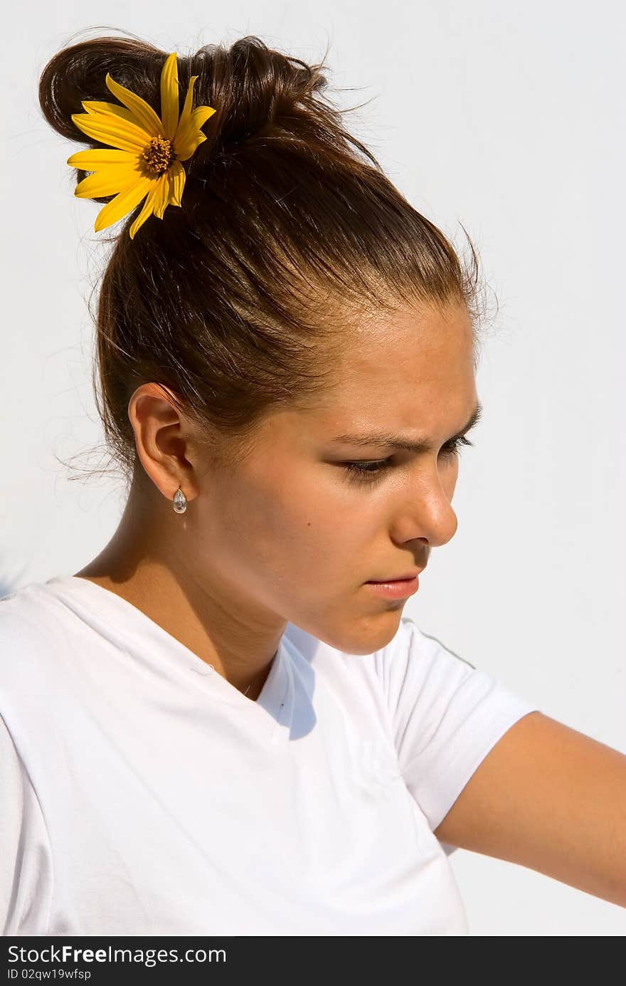 Portrait of the girl in a bright sunny day