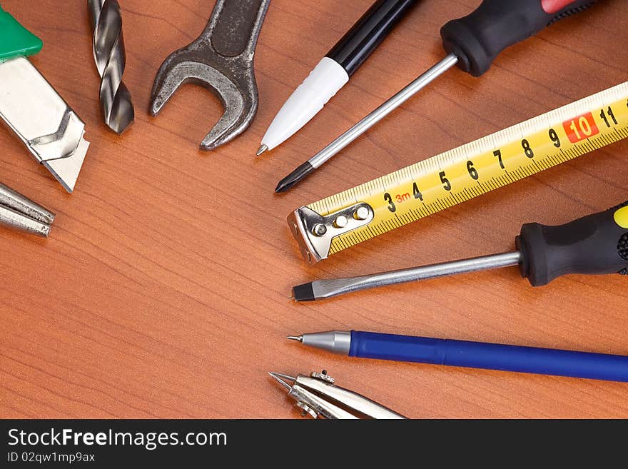 Tools, pencil and pens at table