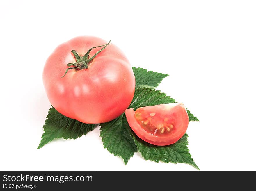 Tomato on a green leaf