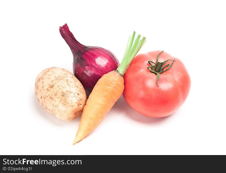 Collection of vegetables: potatoes, tomatoes, onion, cucumber, carrots were taken on a white background