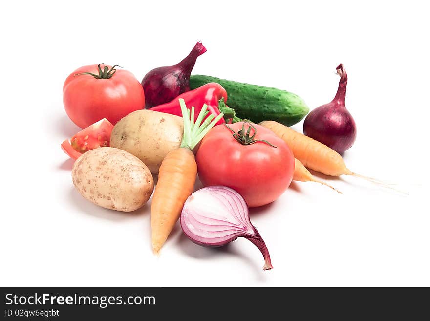 Collection of vegetables: potatoes, tomatoes, onions, cucumbers, peppers, carrots were taken on a white background