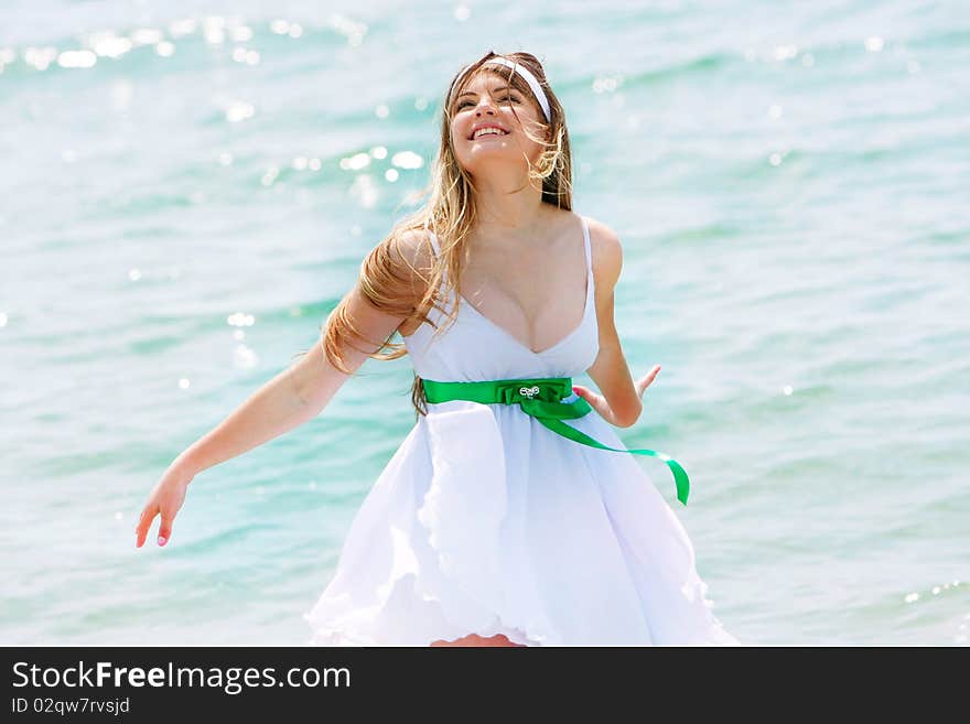 Young happy girl on sea background