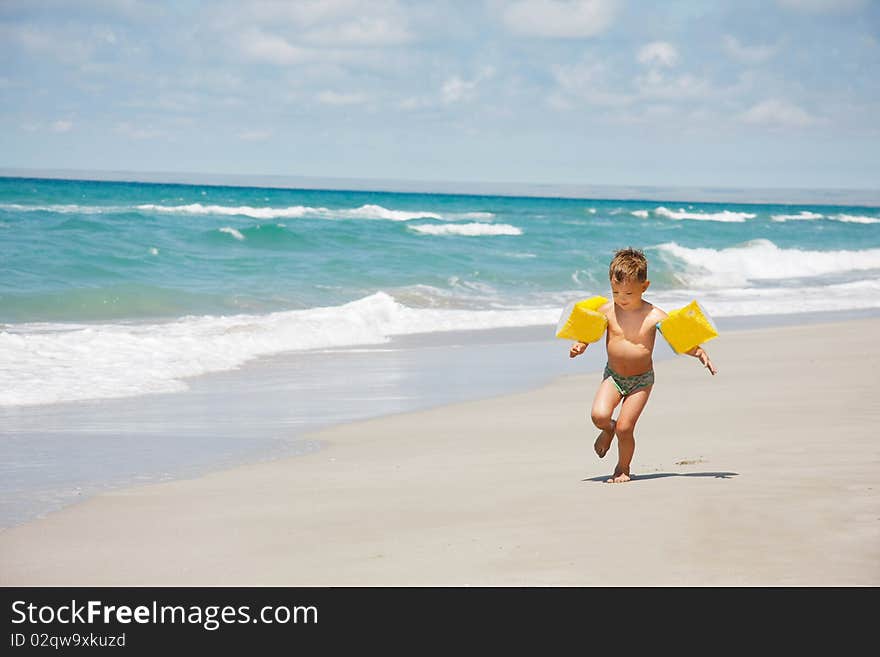 Young boy running on beach