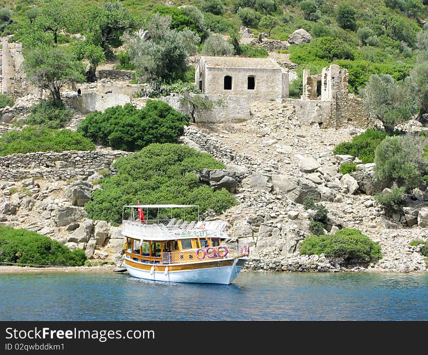 Yacht in aegean sea with view of ancient castle high in mountains. Yacht in aegean sea with view of ancient castle high in mountains