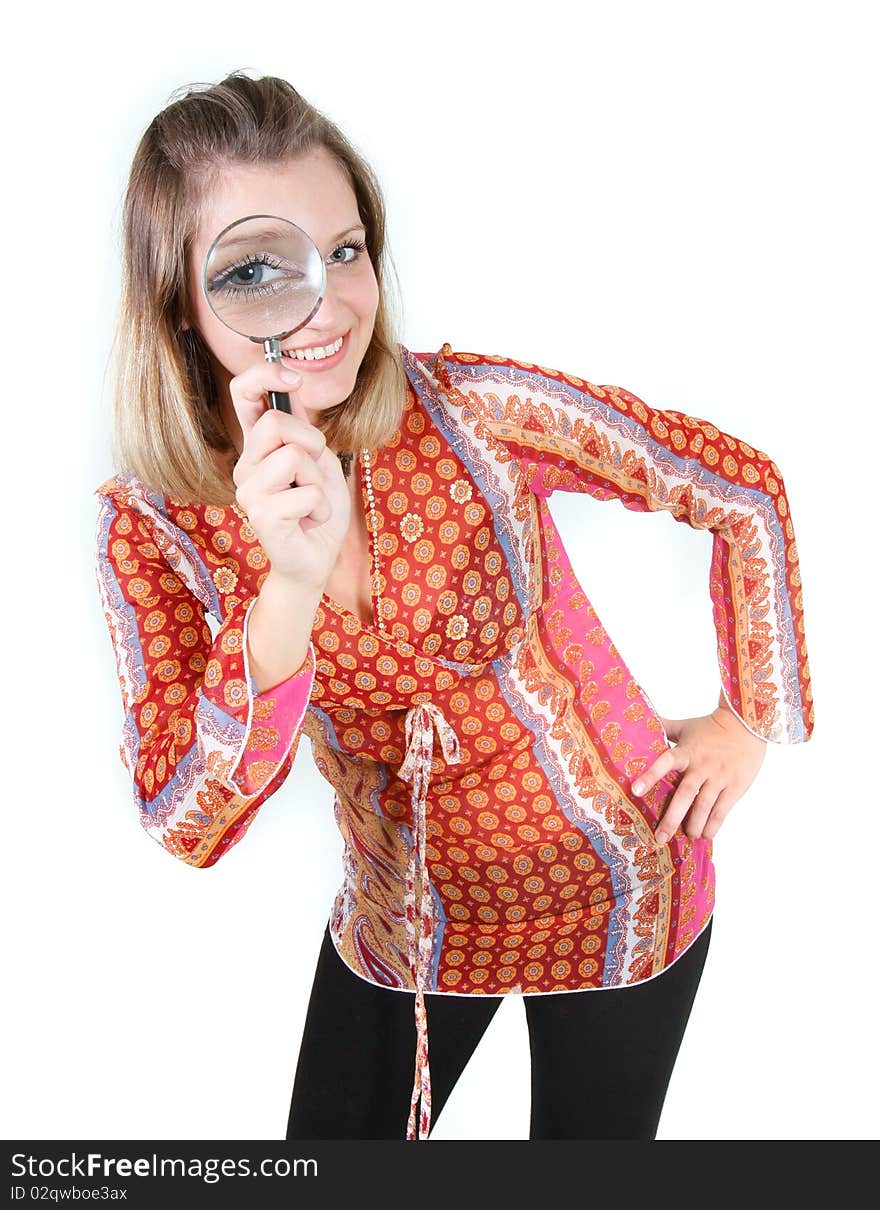 Girl looking through magnifier glass over white